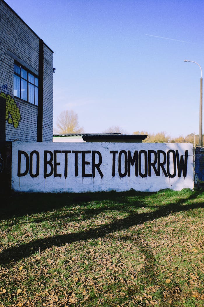 Outdoor graffiti with motivating message Do Better Tomorrow on urban wall.